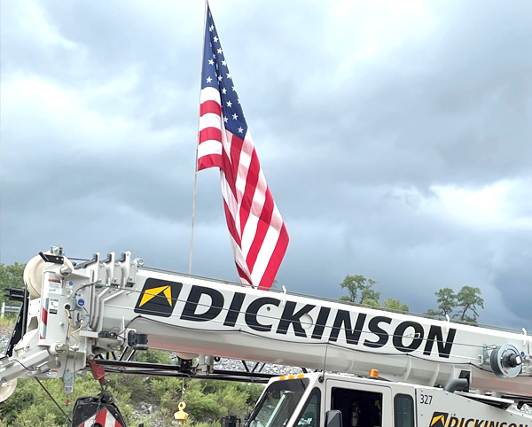 Photo of an American Flag and a truck crane