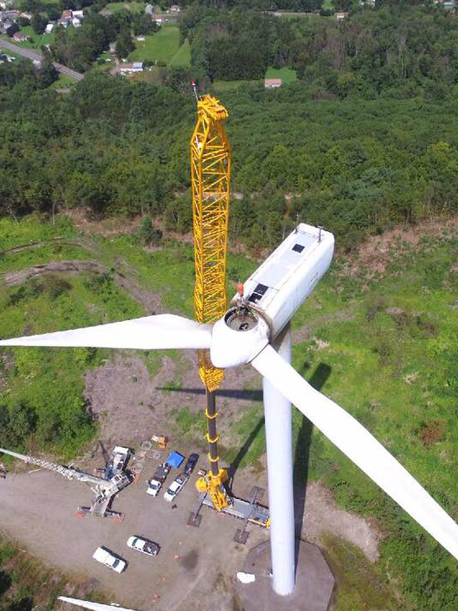 Photo of a crane installing a windmill